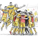 A soccer team in yellow jerseys celebrates, huddled and jumping in celebration on the field with cheering fans in the stands behind them.