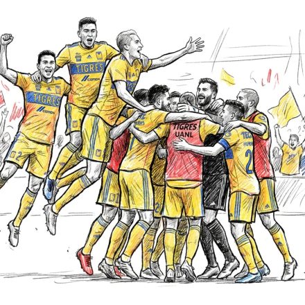 A soccer team in yellow jerseys celebrates, huddled and jumping in celebration on the field with cheering fans in the stands behind them.