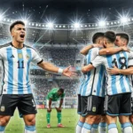 Argentina national team celebrating a goal in a full stadium as a front-forward shouts with arms spread while teammates hug in the background.